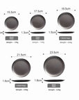 Set of Hakone Plates in varying sizes and weights, showcasing matte stainless steel finish and minimalist design.