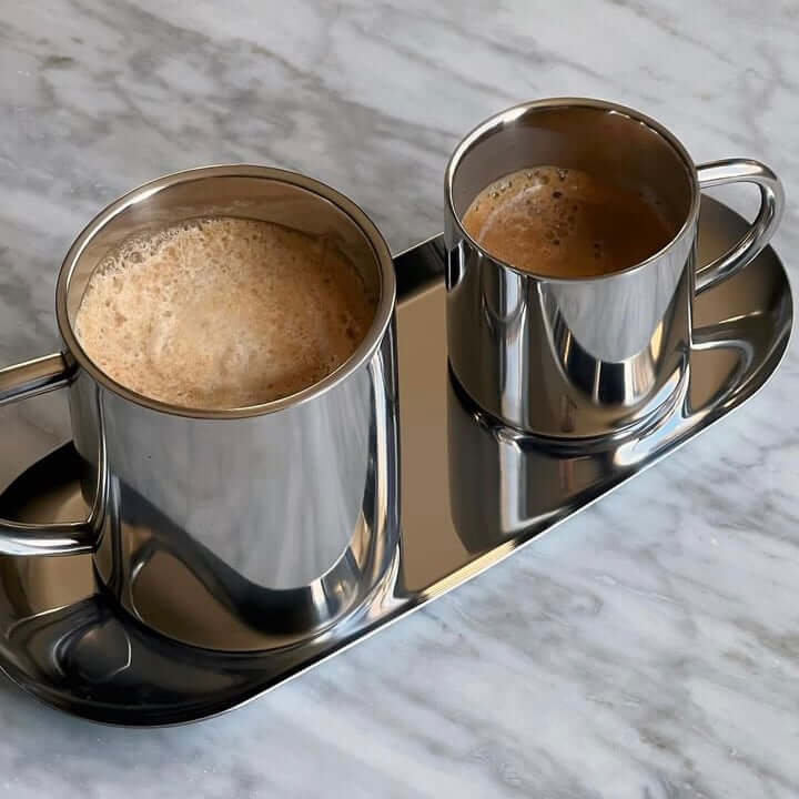 Milano Duo Set with stainless steel double-walled cups on tray, perfect for espresso or latte, on a marble surface.