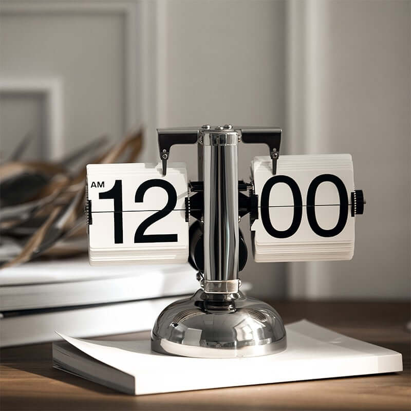 Turning desktop clock with a page-turning mechanism on a book, ideal for Japanese or Nordic inspired interiors.