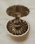 Vintage Metal Shell Box standing open to show the hinged scallop lid