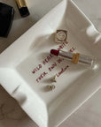 Wild Hearts ceramic tray with the inscription and a lipstick, top view