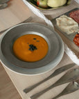 Artisan Pasta Plate with pumpkin soup beside a charcuterie board