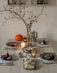 Dinner table set with Artisan Pasta Plates, candles and branches