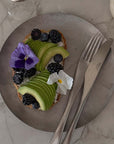 Hakone Plate with avocado toast, berries and a fork on a marble table