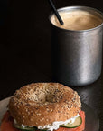 Tetsu Cup with a spoon and coffee beside a bagel sandwich
