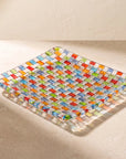 Tessera square platter on a sunlit stone surface, throwing colour onto the stone