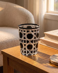 Black Vetra Lattice glass with water on an oak side table