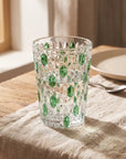 Green Vetra Raindrop glass with water on a linen tablecloth