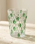 Green Vetra Raindrop glass in sunlight on a stone table