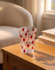 Red Vetra Raindrop glass with water on an oak side table