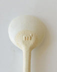 Marumitsu Bean Spoon with rustic semi-matte finish and bean-shaped tip showing unique glaze design on white clay.