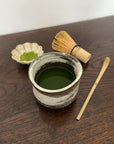 Handmade Wabi-Sabi Matcha Bowl with bamboo whisk and spoon, ceramic design for Japanese tea experience