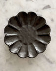 Rinka Plate 14cm black porcelain with floral design, handcrafted in Japan, elegant and microwave safe, on a marble background.