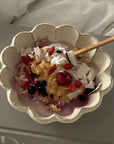 Rinka Bowl 16cm with yogurt and berries, handcrafted by Kaneko Kohyo, showcasing its flower shape and elegance on a table setting.