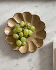Rinka plate with grapes showcasing elegant craftsmanship on marble tabletop.