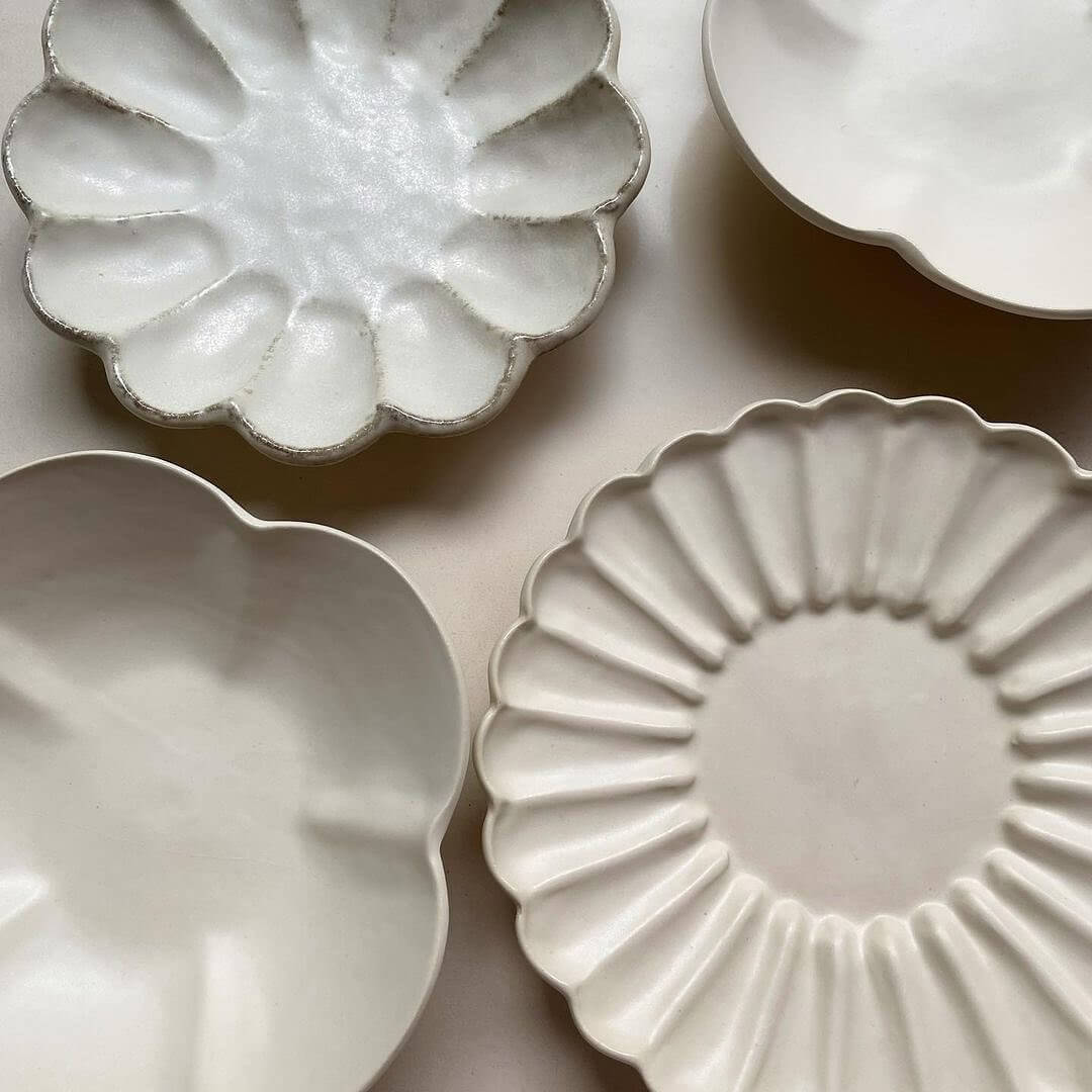 Elegant Yoshida Pottery Collection with Rinka and Yukiwa plates showcasing unique flower-like patterns and refined craftsmanship.