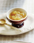 Marumitsu Bean Spoon beside dessert bowl on a table setting with coffee and bread.
