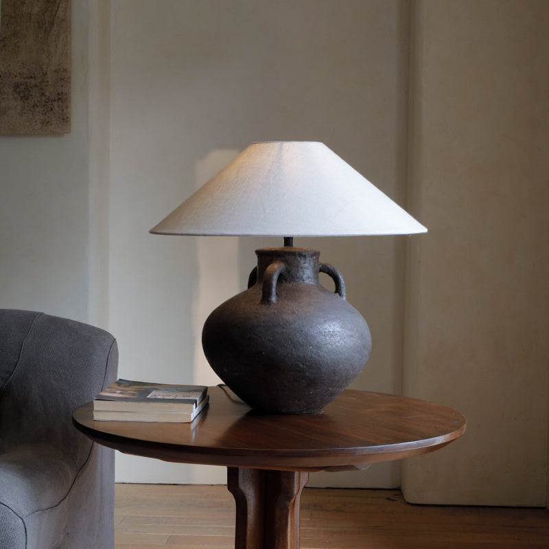 Handmade ear table lamp with old pottery design, unique craftsmanship, soft light diffusion, and warm room ambiance.