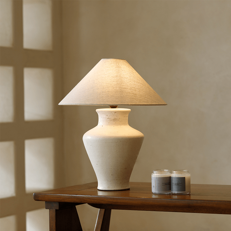 Short Neck Table Lamp with clay base and linen shade, emits warm light, dimmable switch, decorates space with refreshing atmosphere.