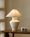 Short Neck Table Lamp with clay base and linen shade, emits warm light, dimmable switch, decorates space with refreshing atmosphere.