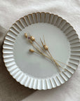 Elegant Marumitsu Barbarie plate with petal-like rim and decorative accents, ideal for adding sophistication to any meal setting.
