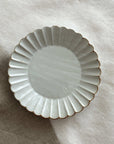 Marumitsu Barbarie plate with petal-like rim design on linen surface, ideal for enhancing meal presentation.