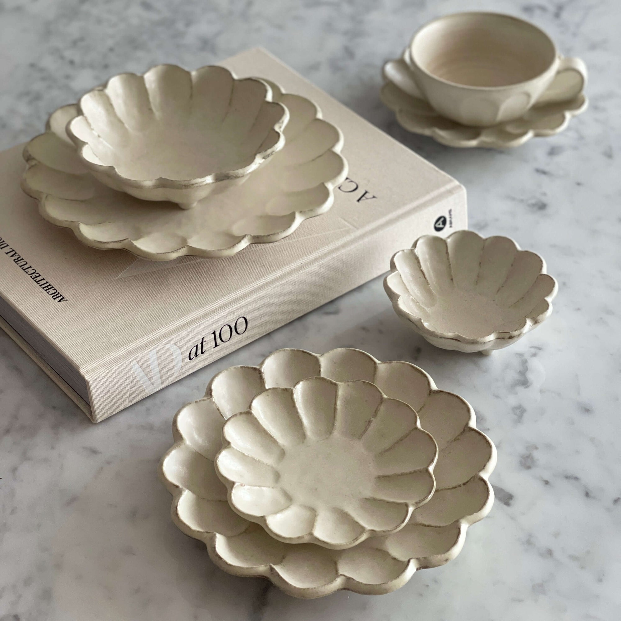 Rinka Bundle 1 Japanese porcelain dishes with elegant flower petal design on a marble surface, showcasing craftsmanship and style.