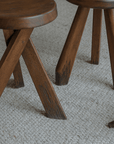 Meribel stool made of imported teak wood with a design inspired by the Alps, featuring manual polishing and charcoal burning finish.