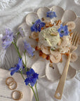 Elegant Rinka Plate with dessert, blue flowers, and gold fork on a table, showcasing Japanese craftsmanship and aesthetic beauty.