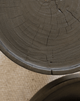 Close-up of the Seal Coffee Table showcasing its natural log texture and carbonized black surface, highlighting its elegance and durability.