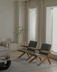 Modern living room with two teak wood Scissors Chairs showcasing sleek design, comfort, and style.