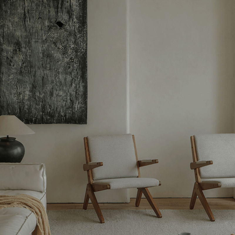 Elegant Scissors Chair with teak wood frames in minimalist living room setting, featuring comfortable lounge design.