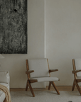 Elegant Scissors Chair with teak wood frames in minimalist living room setting, featuring comfortable lounge design.
