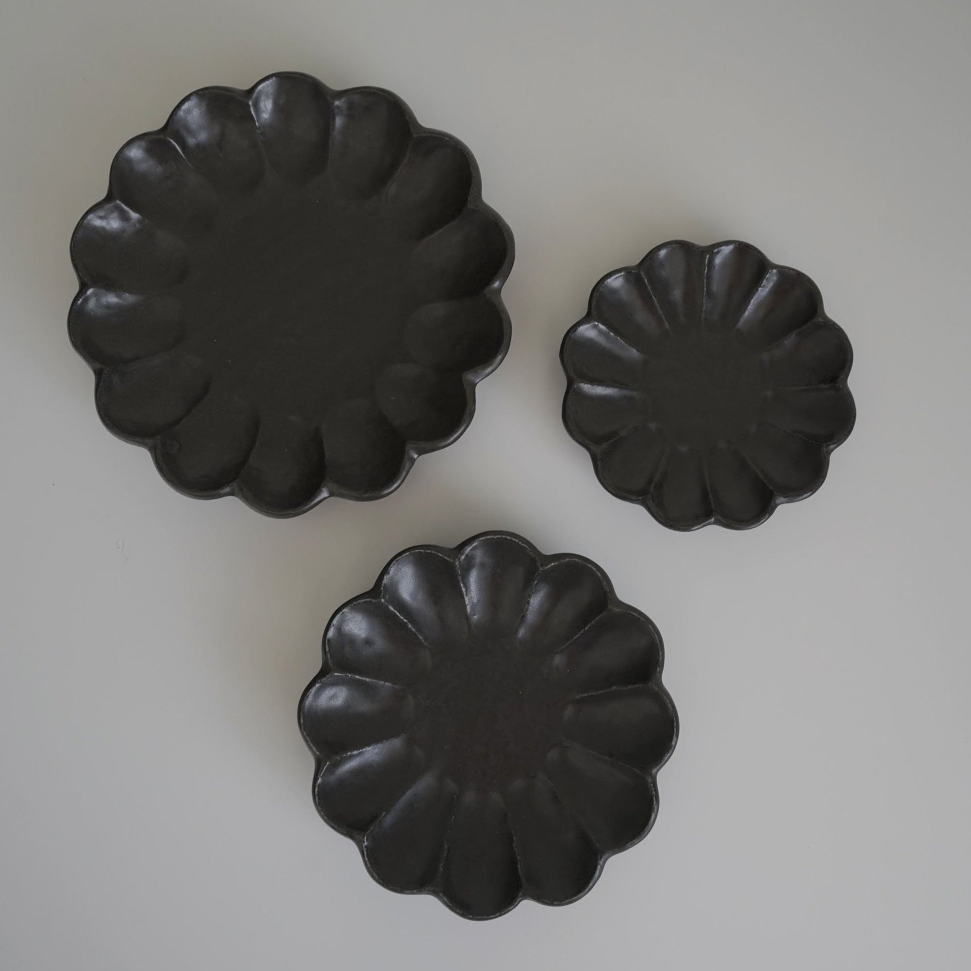Rinka Collection black porcelain plates in three sizes, handcrafted in Japan.