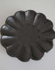 Elegant black Rinka Plate 21cm crafted in porcelain, featuring a unique flower-like design, part of Kaneko Kohyo's Japanese collection.
