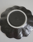 Bottom view of a 14cm Rinka porcelain plate showcasing its wavy design and craftsmanship from the Rinka Collection.