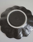 Black Rinka Plate 17cm, handcrafted porcelain, underside view, elegant wave design, Kaneko Kohyo, made in Japan.