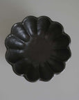 Black Rinka Bowl 12cm in flower shape from Kaneko Kohyo's porcelain collection, perfect for enhancing table settings.