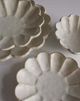 Rinka Collection porcelain plates handcrafted in Japan, showcasing elegant scalloped design, perfect for enhancing table aesthetics.