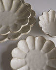 Rinka Collection porcelain plates handcrafted in Japan, showcasing elegant scalloped design, perfect for enhancing table aesthetics.