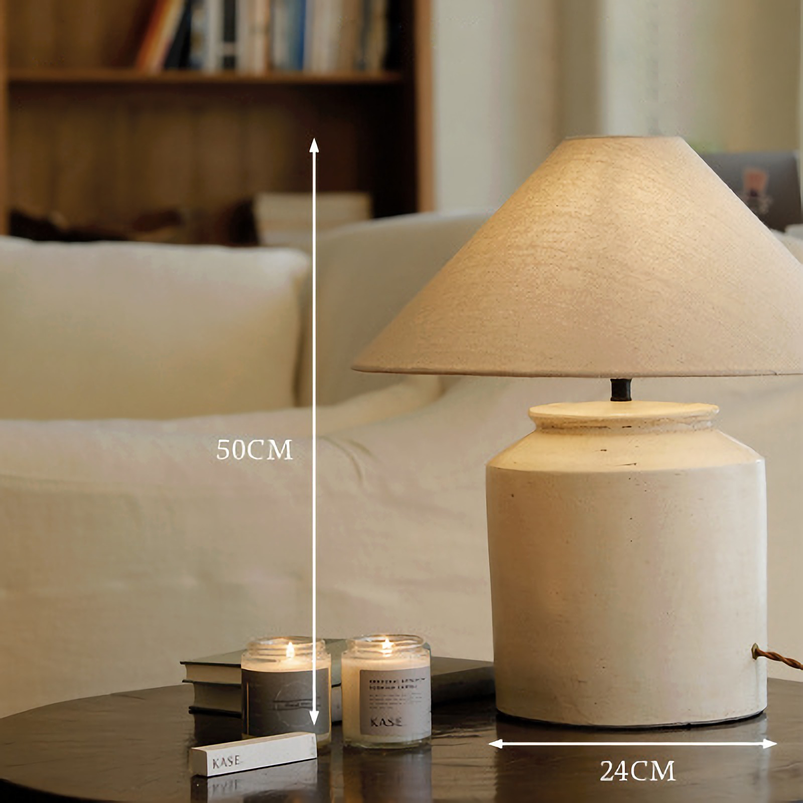 Folding Shoulder Table Lamp on a wooden table with candles, featuring a linen lampshade, clay base, and warm adjustable light.