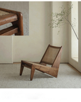 Kangaroo Chair featuring a Z-shaped design with rattan seat, solid wood frame, and thin painted surface in a minimalist interior.
