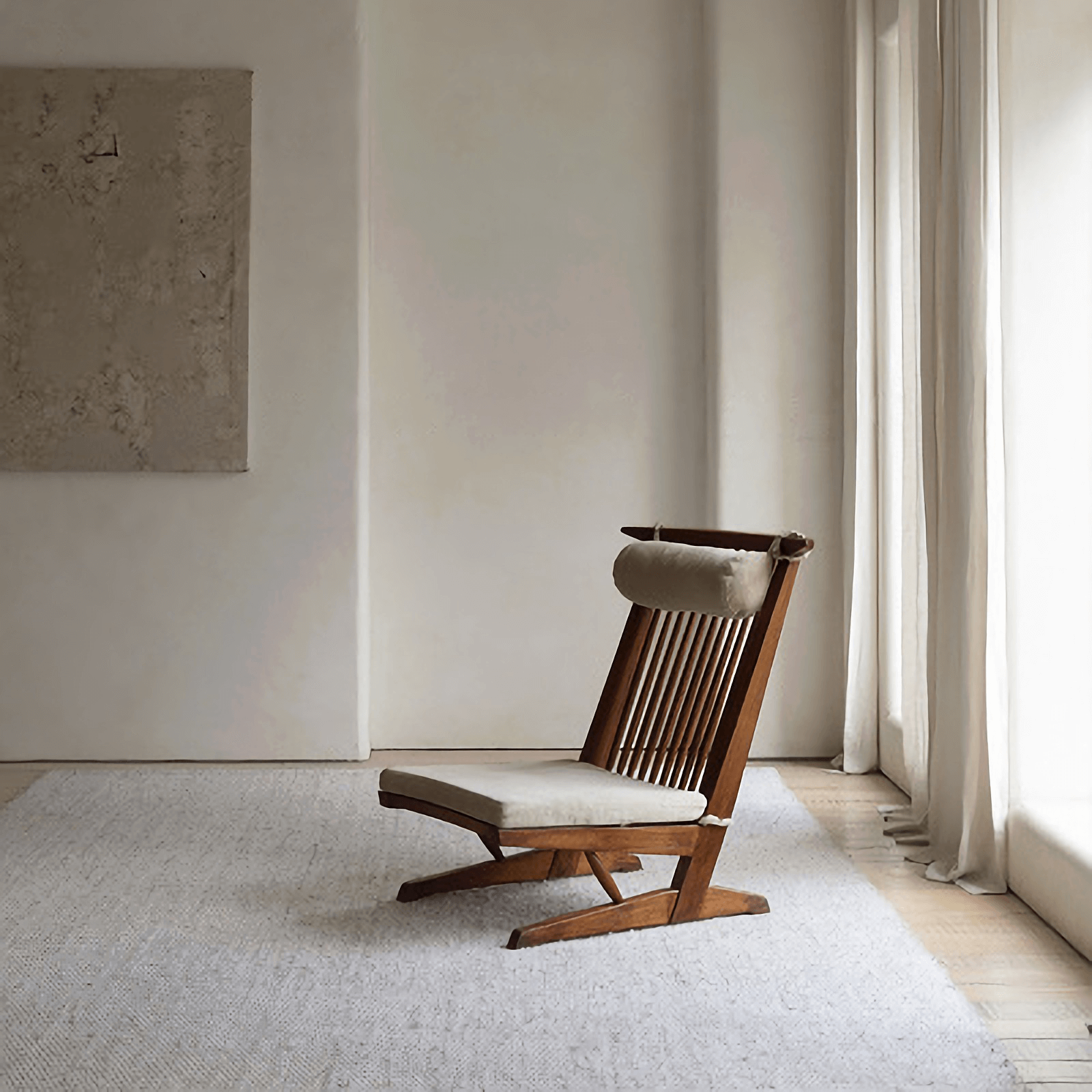 Nakajima George reclining chair made of teak and rattan in a minimalist room, showcasing handcrafted elegance and natural materials.