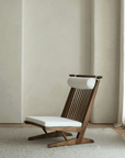 Nakajima George Reclining Chair with hand-woven rattan and teak wood frame, offering a romantic and elegant design for interiors.