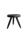 Black Meribel Stool made of imported teak wood inspired by the architectural style of the Alps, featuring manual polishing and charcoal finish.