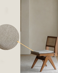 Solid wood rattan dining chair with gray cushion, showcasing hand-woven teak frame and intricate rattan backrest design.