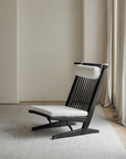 Nakajima George Reclining Chair in teak wood with rattan weave and natural linen, handmade for a romantic and elegant ambiance.