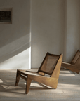 Two Kangaroo Chairs with rattan and solid wood in a minimalist room, showcasing a stylish "Z" shaped design and sleek finish.