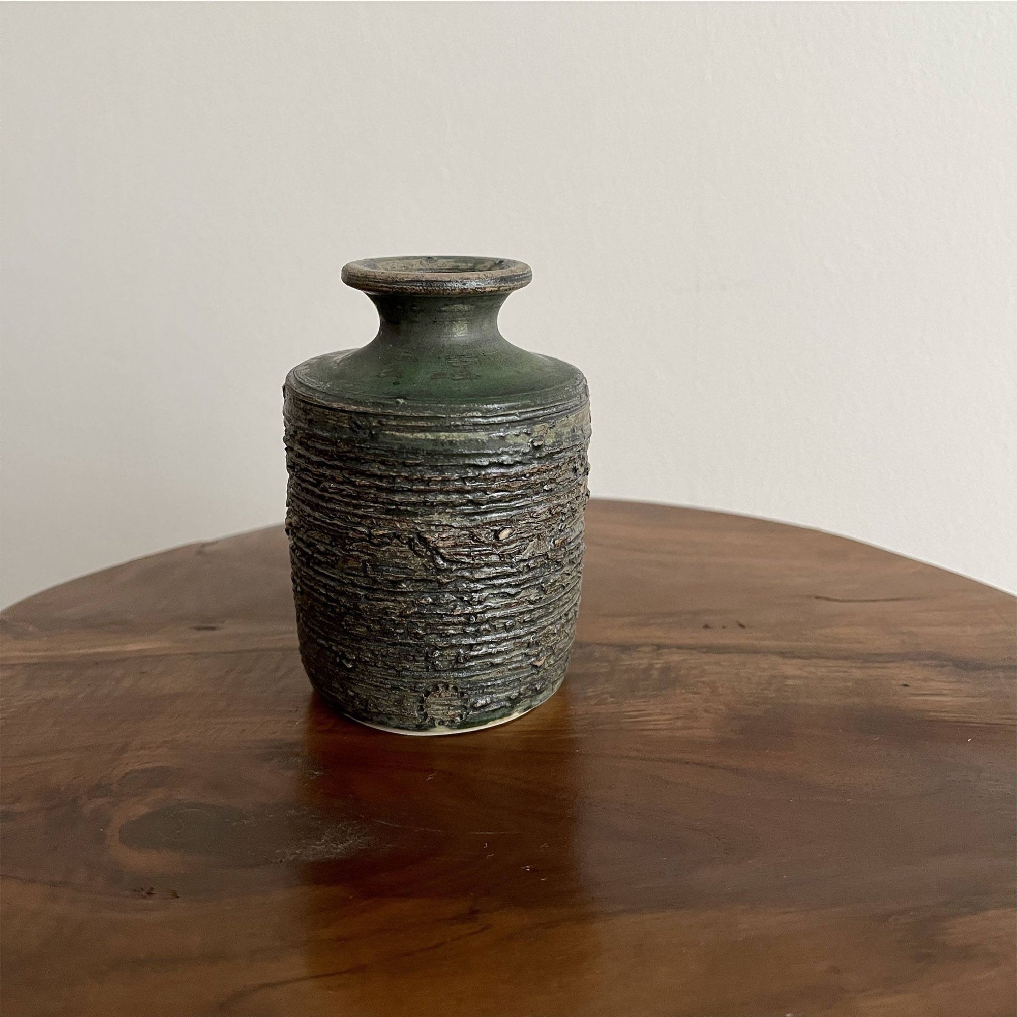 Shabby Chic Green Vase from Yoshida Pottery Collection, designed by Masakazu Yoshida, on a wooden table.