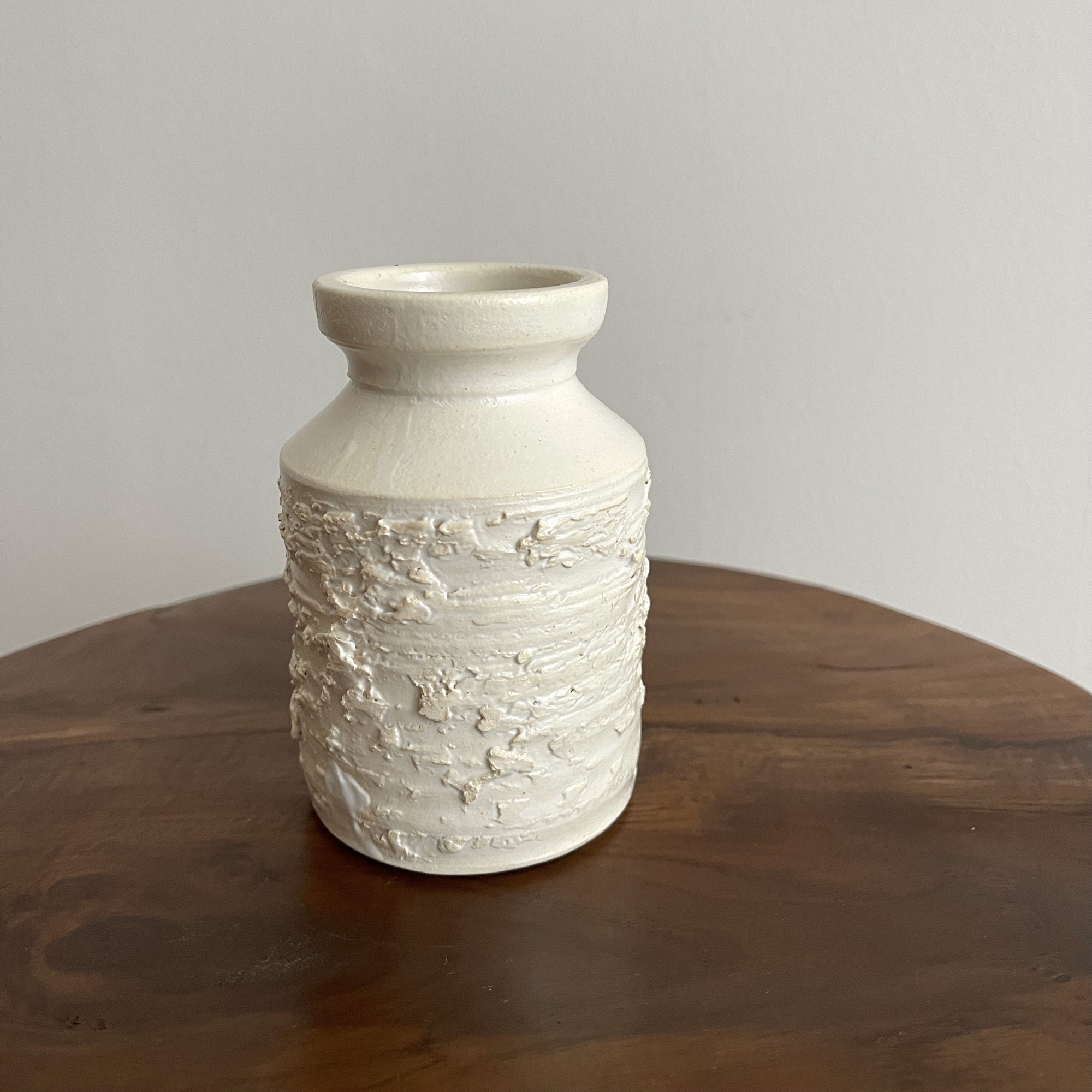 Elegant white vase from Yoshida Pottery Collection with nature-inspired patterns by Masakazu Yoshida, adding a refined touch to decor.